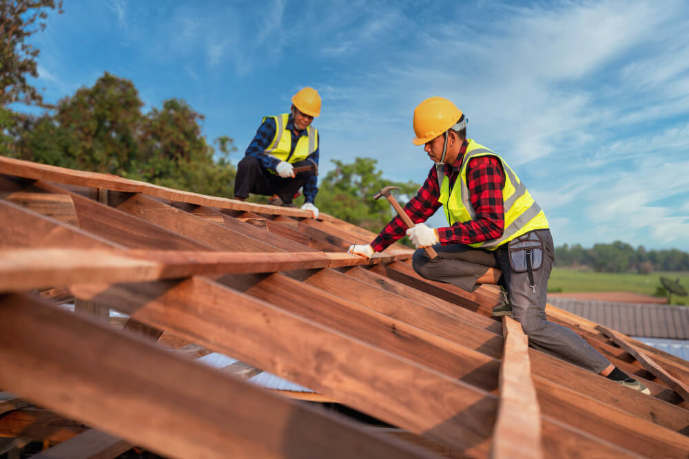  Two Roofer Carpenter Working On Roof Structure On Construction Site